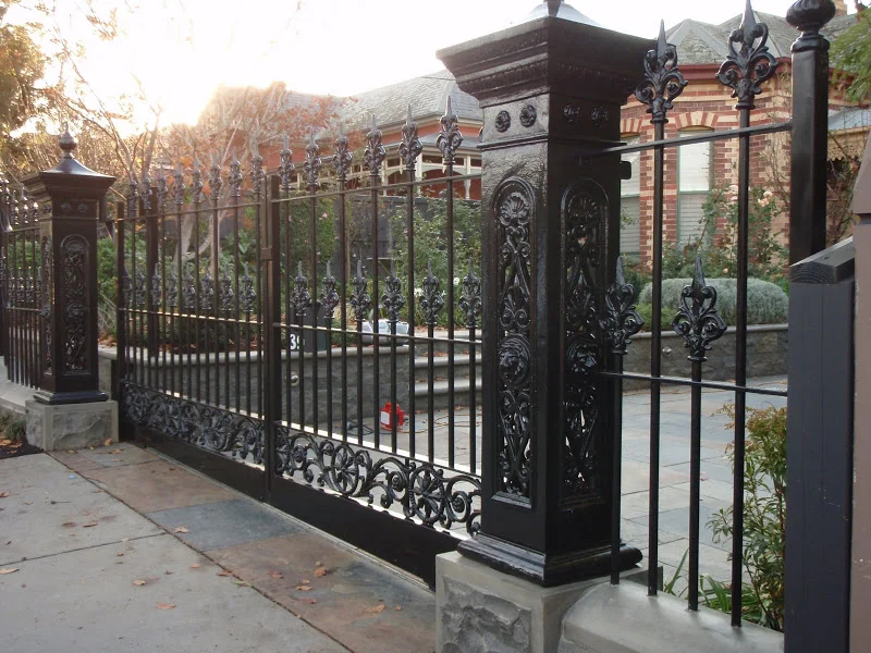 Black wrought iron fence and double swing gates